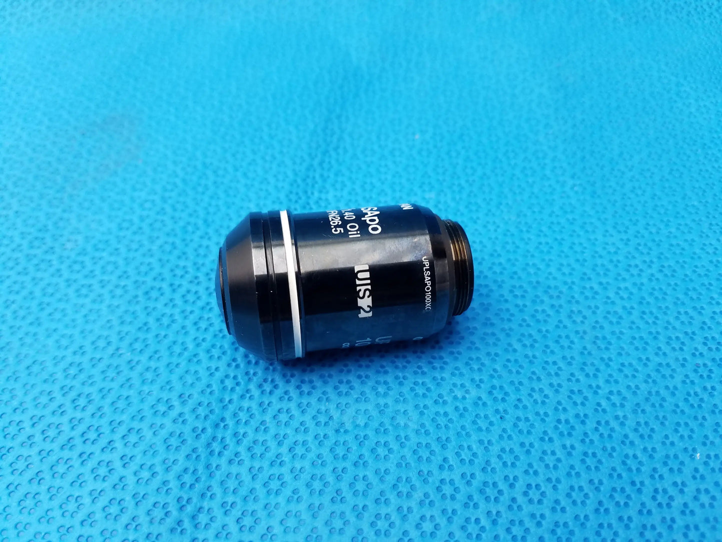 Black Nikon microscope objective lens with silver ring and engraved numerical aperture compatible with Olympus use