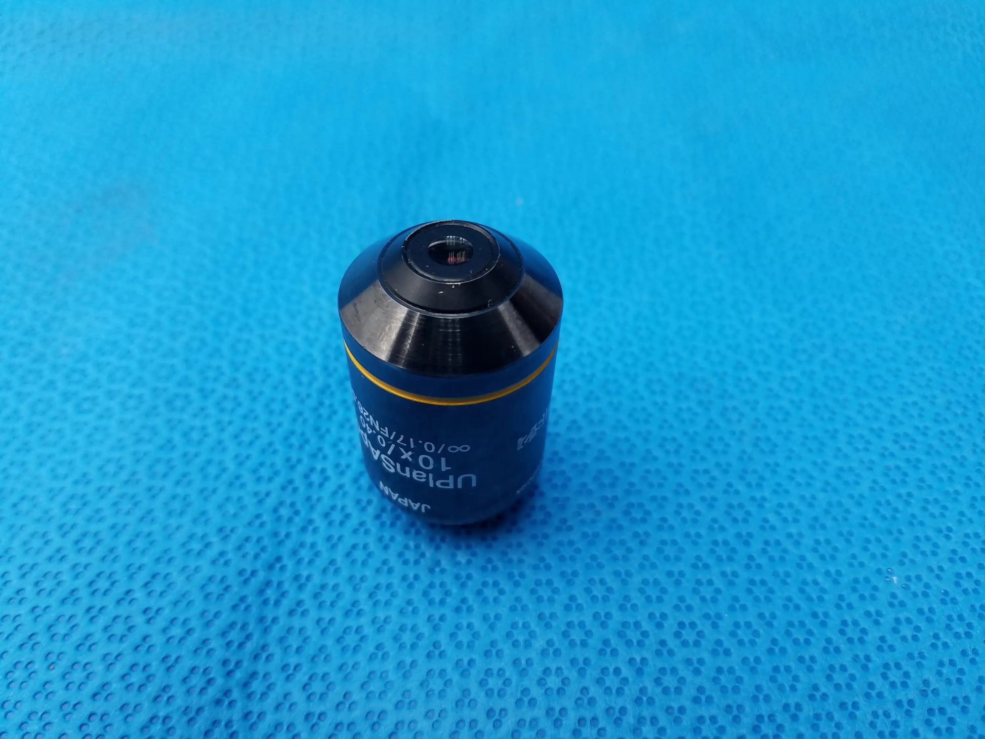 Black and yellow microscope objective lens with upm branding compatible olympus uplansapo 10x for precise imaging