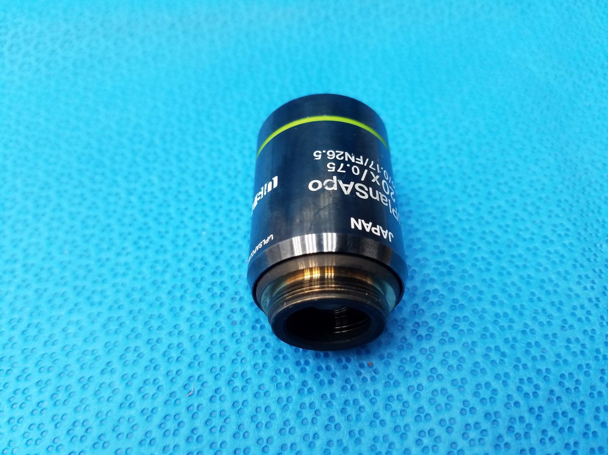 Olympus uplanSApo 20x microscope objective lens with numerical aperture 0.75 and field number 26.25 featuring green accent ring