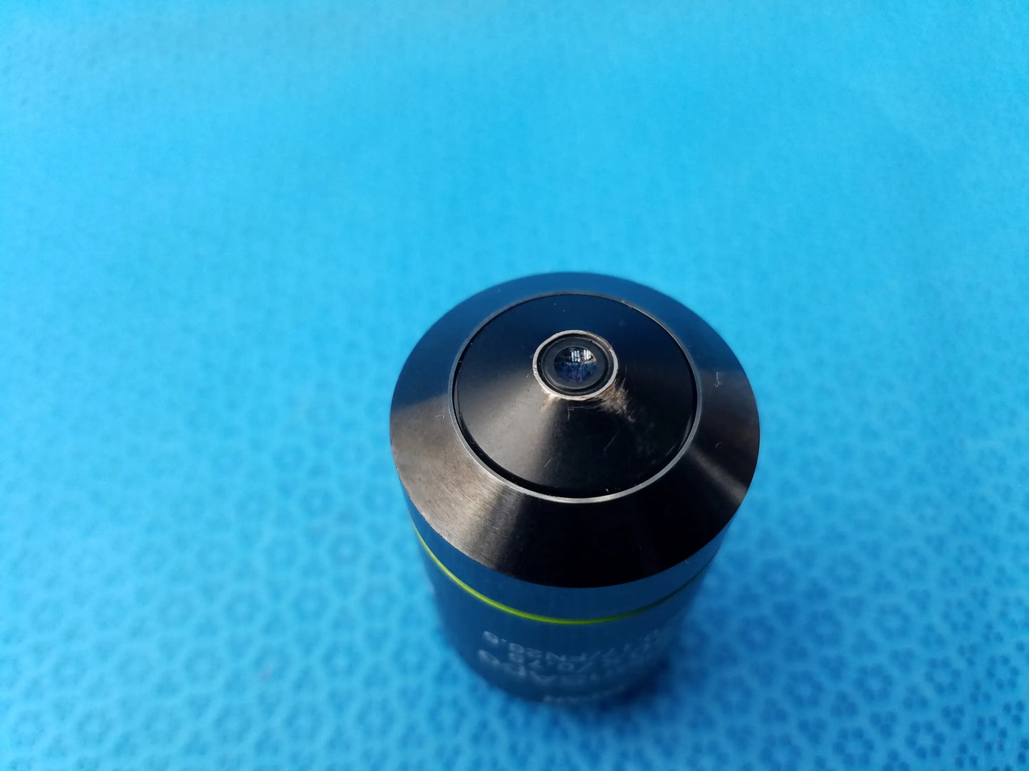 Black cylindrical microscope objective lens with metallic finish green accent stripe Olympus UPlanSApo numerical aperture field number