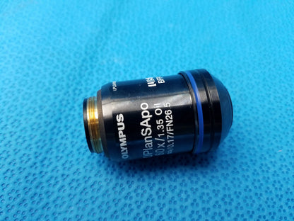 Black Olympus UPlanSApo 60x oil immersion microscope objective lens with gold threading, blue ring, numerical aperture 1.35, FN26.5 field number