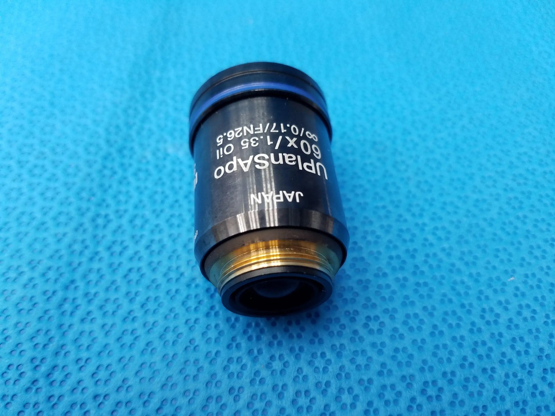 Olympus UPlanSApo 60x oil immersion microscope objective lens with gold threaded mount featuring high numerical aperture and field number