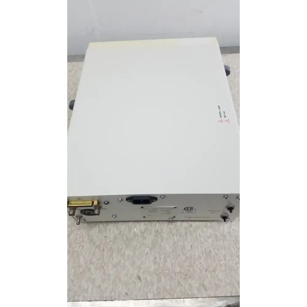 White rectangular Olympus Visera CLV-S40 emergency lamp with metallic connectors and gold-plated port on side
