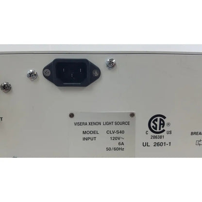 Back side of olympus visera clv-s40 emergency lamp showing white xenon light source with black power socket and metallic screws