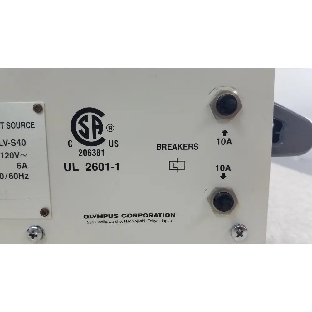 White olympus visera clv-s40 emergency lamp power supply unit with black hexagonal terminal screws and labeled breakers