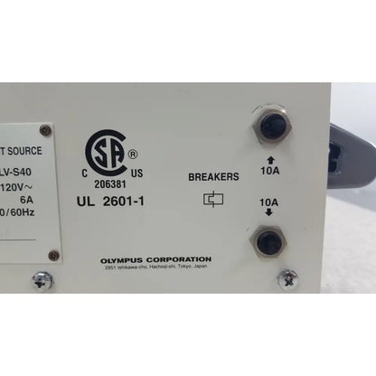White olympus visera clv-s40 emergency lamp power supply unit with black hexagonal terminal screws and labeled breakers
