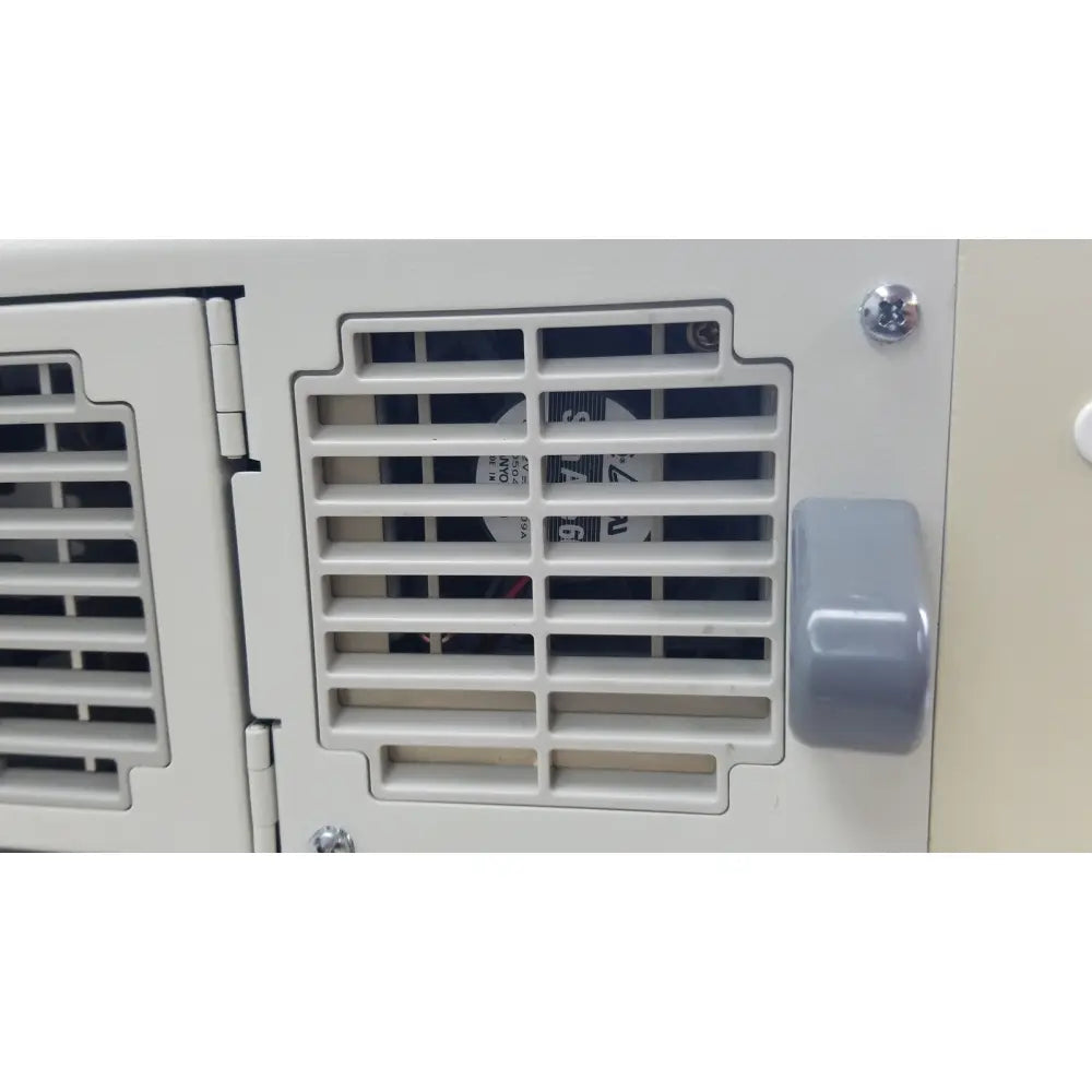 Gray plastic handle on a white ventilation grille of the olympus visera clv-s40 emergency lamp for medical use