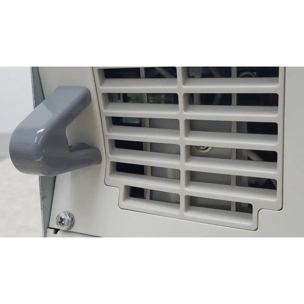 Gray plastic handle with smooth curved design attached to white vented panel of olympus visera clv-s40 emergency lamp