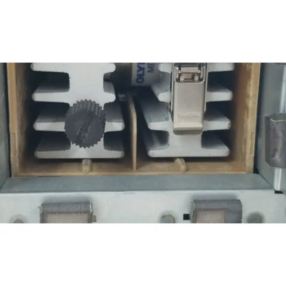 Silver-colored metal clamp with a textured dark gray gear-like knob on the olympus visera clv-s40 emergency lamp