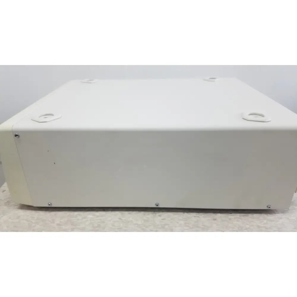 White rectangular metal box with four circular indentations and screws on edges of olympus visera elite xenon light source