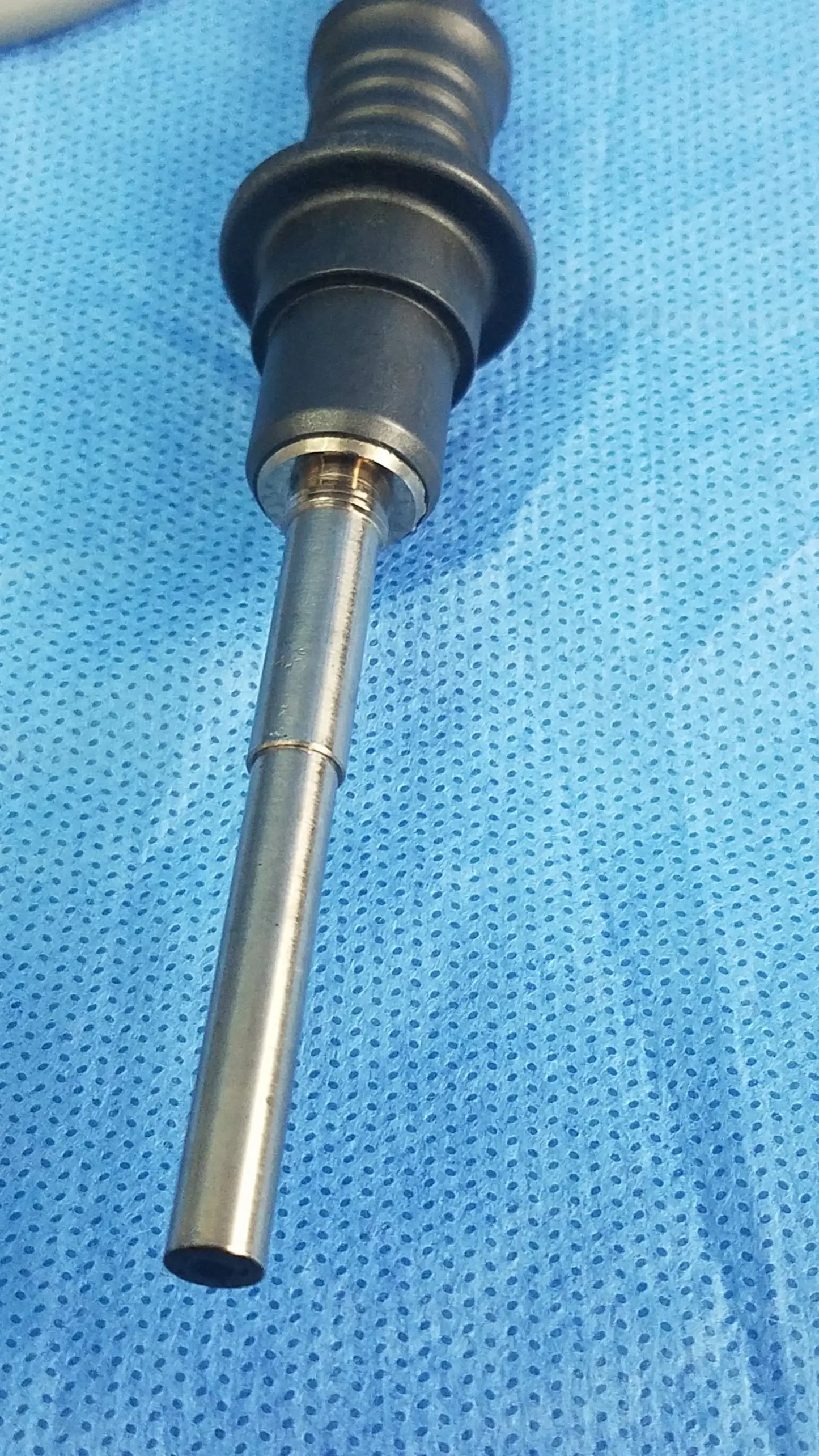 Black and silver Olympus WA03200A fiber optic light cable with textured grip handle for surgical use
