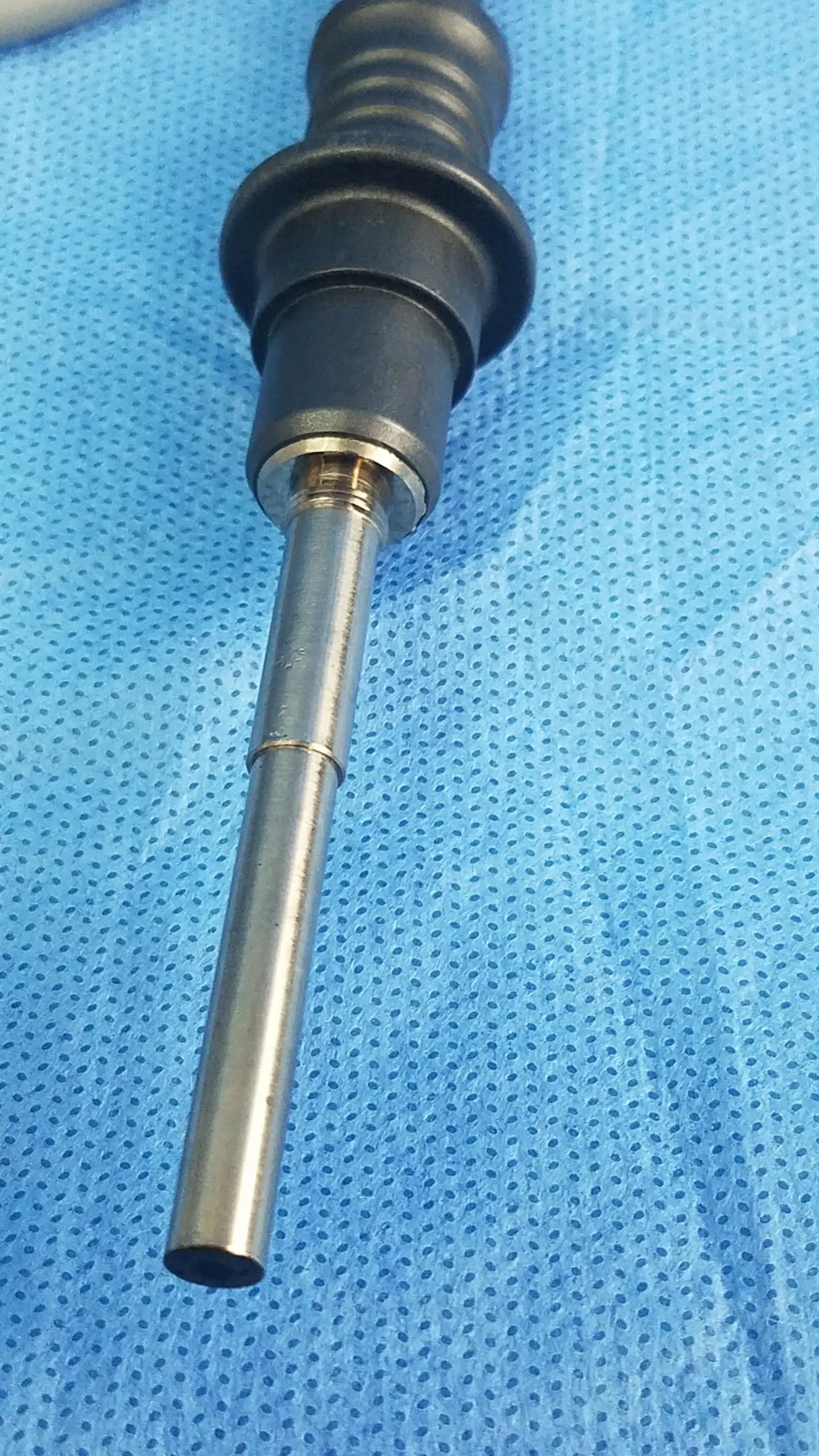 Black and silver Olympus WA03200A fiber optic light cable with textured grip handle for surgical use