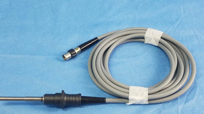 Gray coiled Olympus WA03200A S fiber optic light cable with black and metallic connectors for medical endoscope use