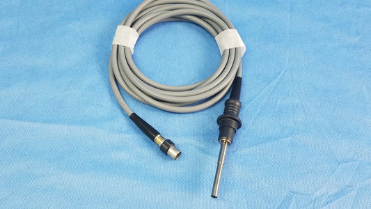 Gray coiled Olympus WA03200A s fiber optic light cable with black connectors and metallic tip for surgical use