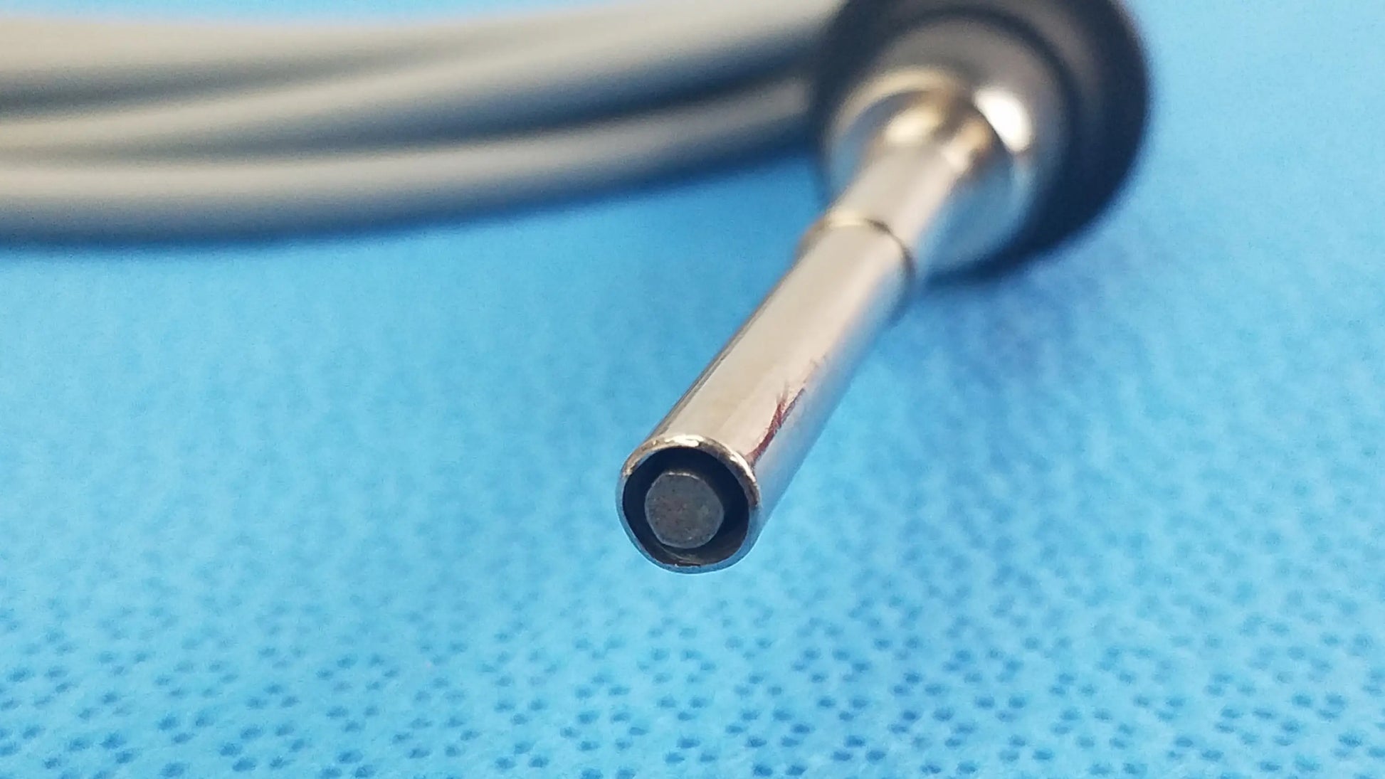 Silver-tipped olympus wa03200a s fiber optic light cable with black rubberized grip and coiled gray cable for medical equipment