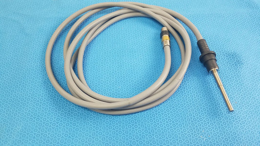 Gray coiled medical equipment cable with black metallic connector for olympus wa03300a light guide use