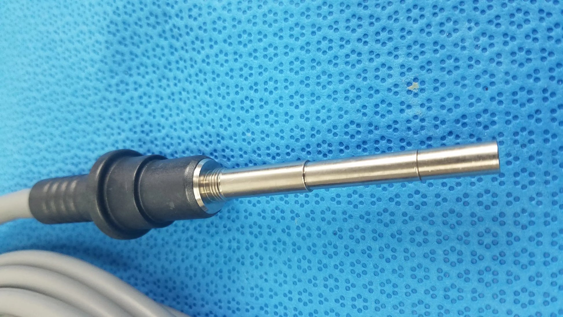 Silver metallic probe with black plastic housing and gray cable for olympus wa03300a light guide in medical equipment