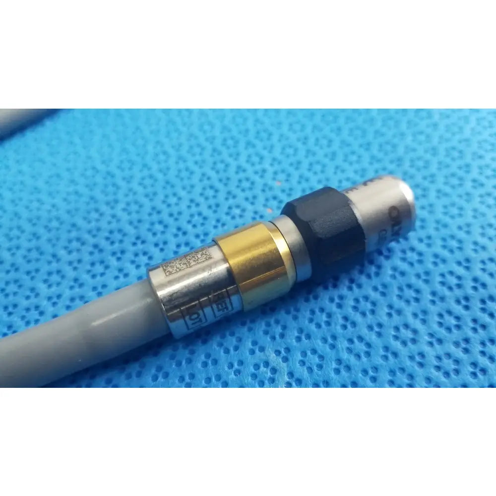 Gray cable with metallic brass and black connector for olympus wa03300a light guide used in medical equipment