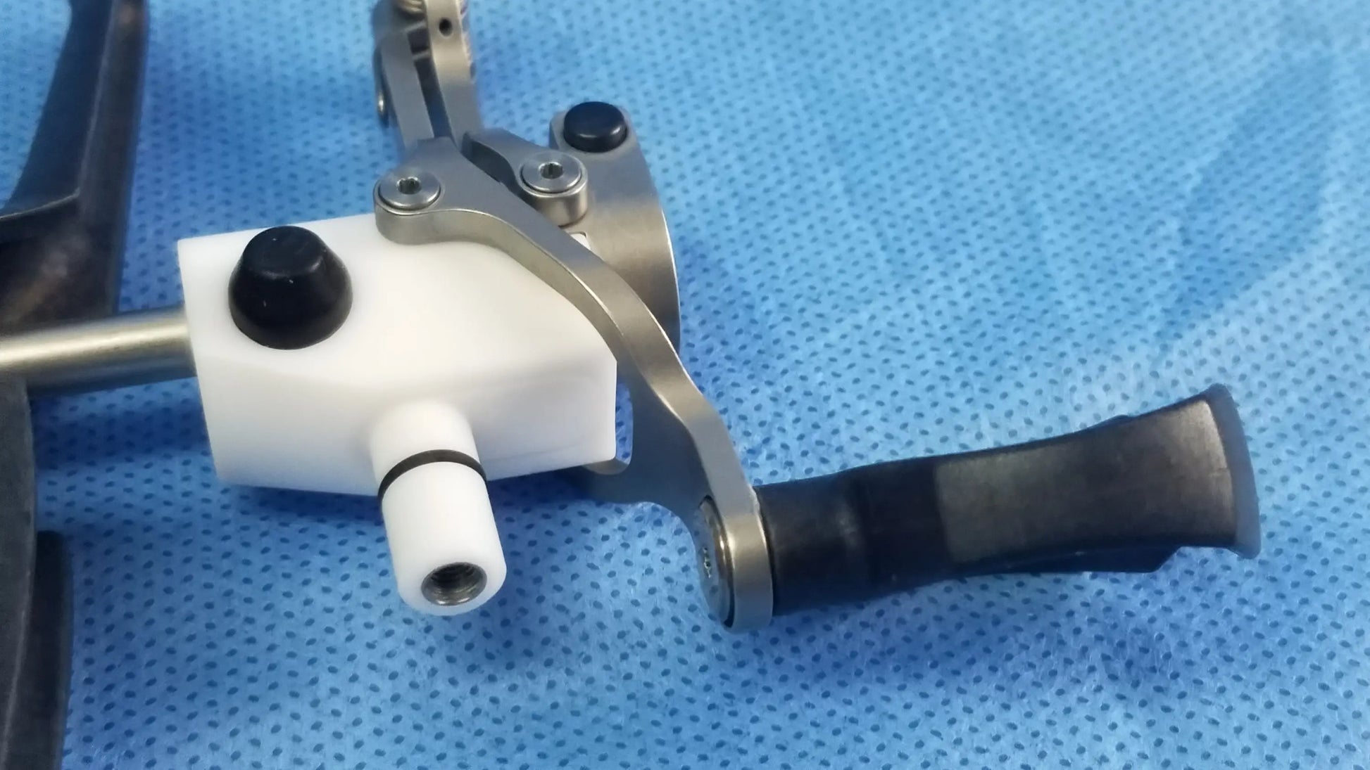 Olympus WA22067A passive monopolar working element with white plastic body, metallic arm, and black rubberized grip