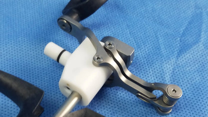 Silver-toned metal passive monopolar working element with white plastic handle and black grip for surgical use