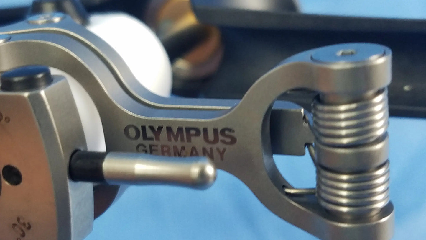 Silver metallic Olympus Germany branded passive working element with coiled spring and precision-engineered components