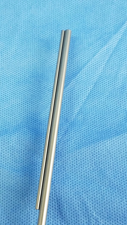 Two polished silver metallic rods of the Olympus WA22367A bipolar passive working element on a blue surface