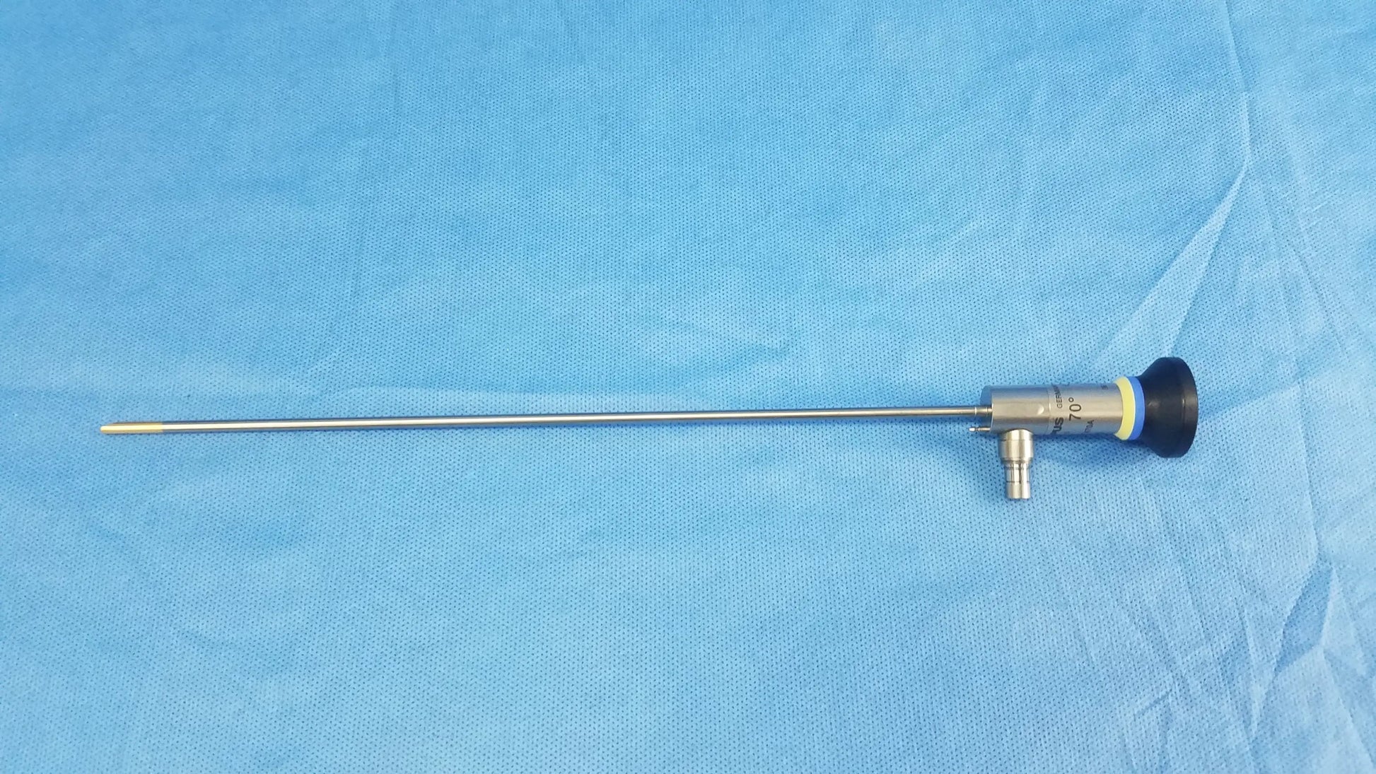 Silver oes elite wa2t470a rigid telescope with black handle and yellow accent ring designed for surgical use
