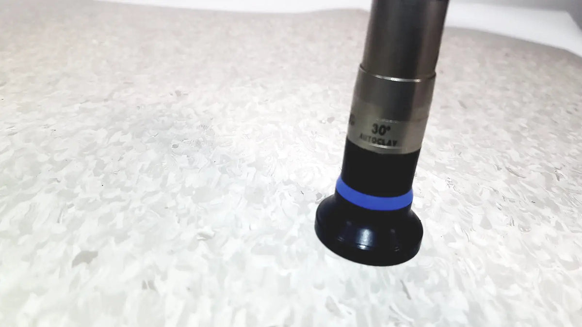 Black and silver olympus wa50373 autoclaveable laparoscope with blue ring near the base used for medical procedures