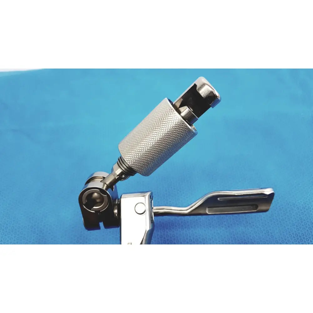 Silver surgical support arm with textured mesh handle and three slots in flat paddle head for stable surgical retraction