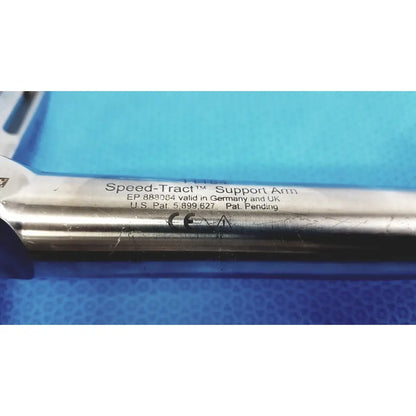 Silver metallic speed-tract support arm with engraved patent markings for stable surgical retraction support
