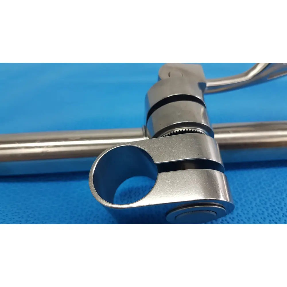 Stainless steel surgical clamp with polished metallic finish and interlocking rings for speed-tract field post use