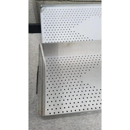 Stainless steel perforated tray with raised edges and grid holes for sterilization in omni tract 3422r drain pan