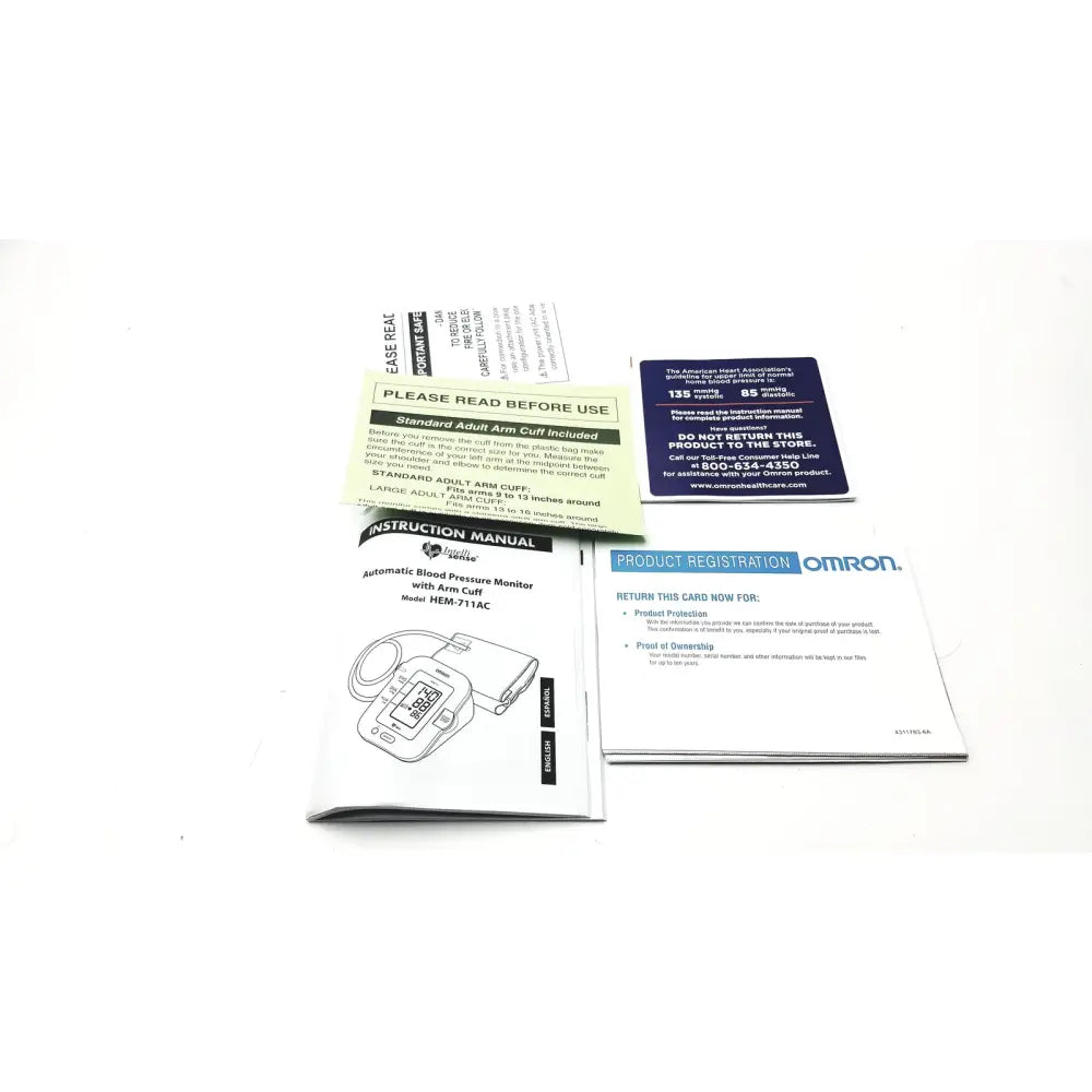 Omron advanced blood pressure monitor HEM-711AC with arm cuff, compact digital display, and included instruction manual