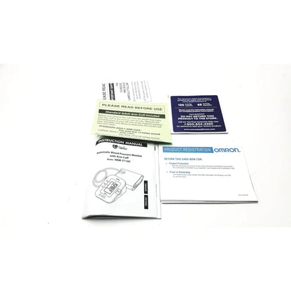 Omron advanced blood pressure monitor HEM-711AC with arm cuff, compact digital display, and included instruction manual