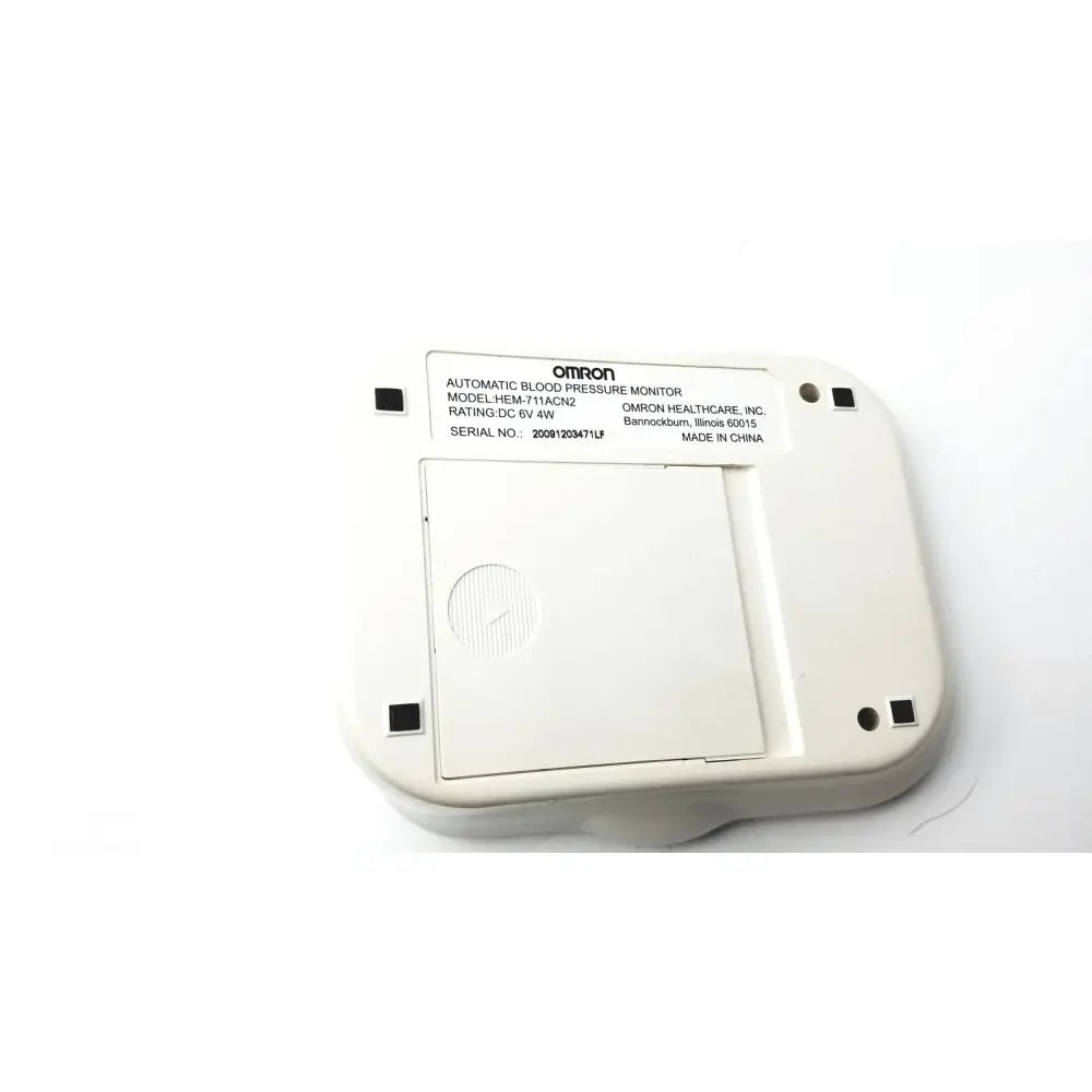 White omron advanced blood pressure monitor model hem-711ac back panel with four black square ports for connectivity
