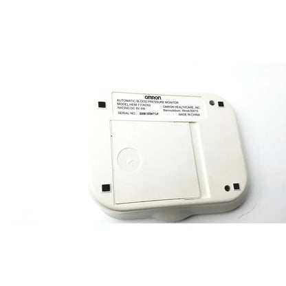 White omron advanced blood pressure monitor model hem-711ac back panel with four black square ports for connectivity