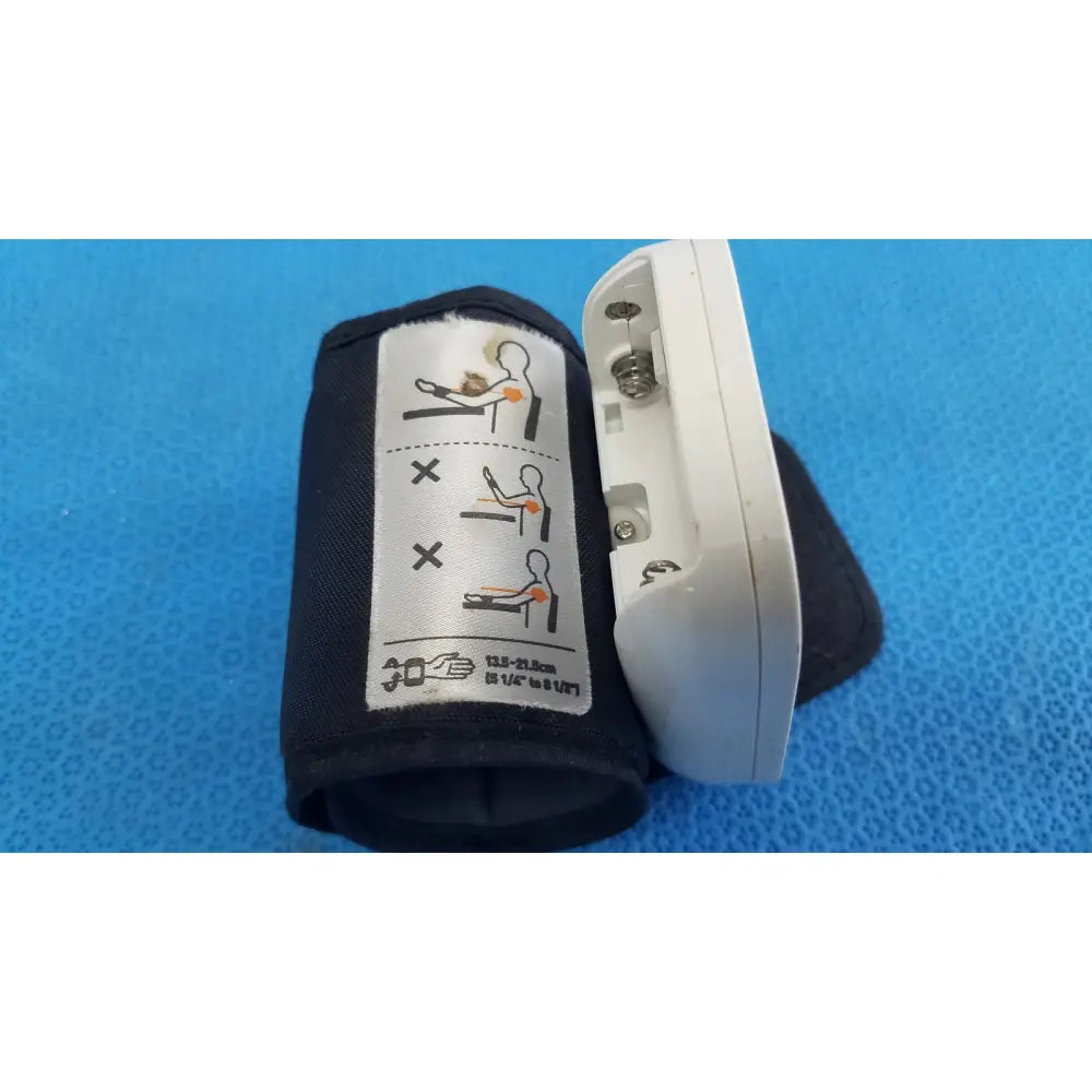 White omron automatic wrist blood pressure monitor with black cuff featuring instructional diagrams and size specifications