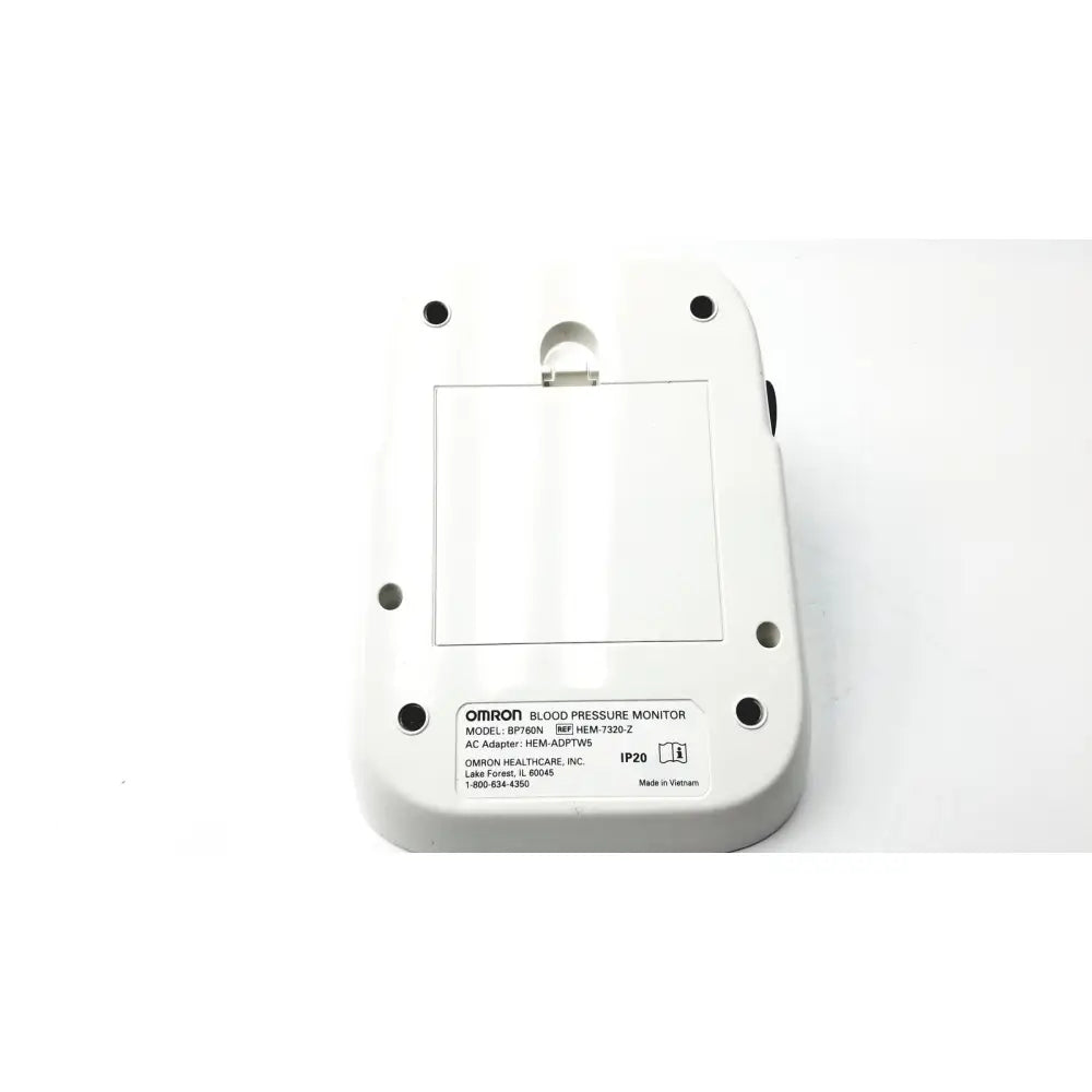 White plastic omron bo760n blood pressure monitor showing rectangular label with model specifications on back side