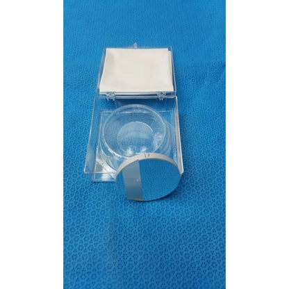 Clear circular glass optical container with silvered mirror surface and white label by Spawr Industries