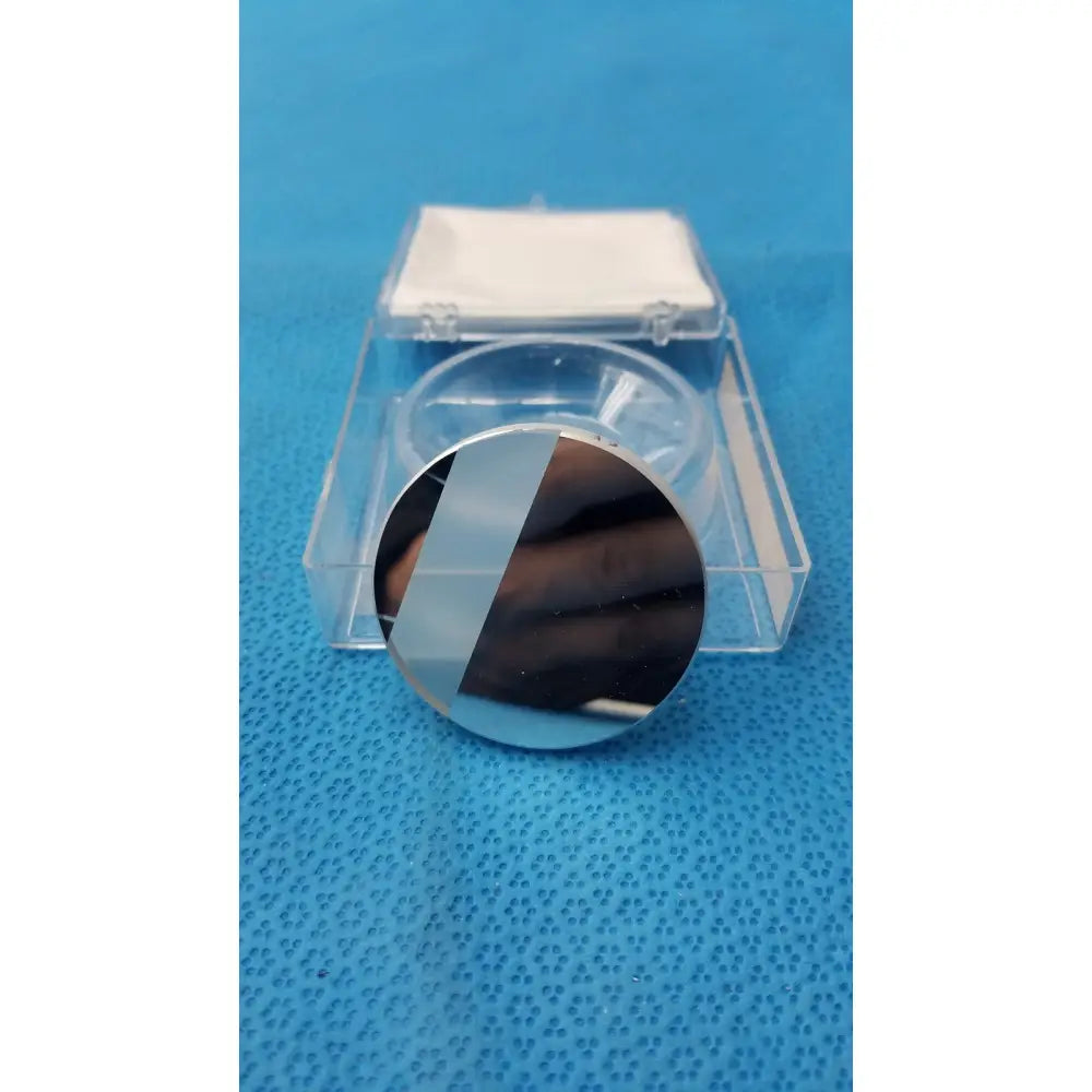 Optical container by spawr industries with a circular reflective silicon wafer and diagonal stripe pattern