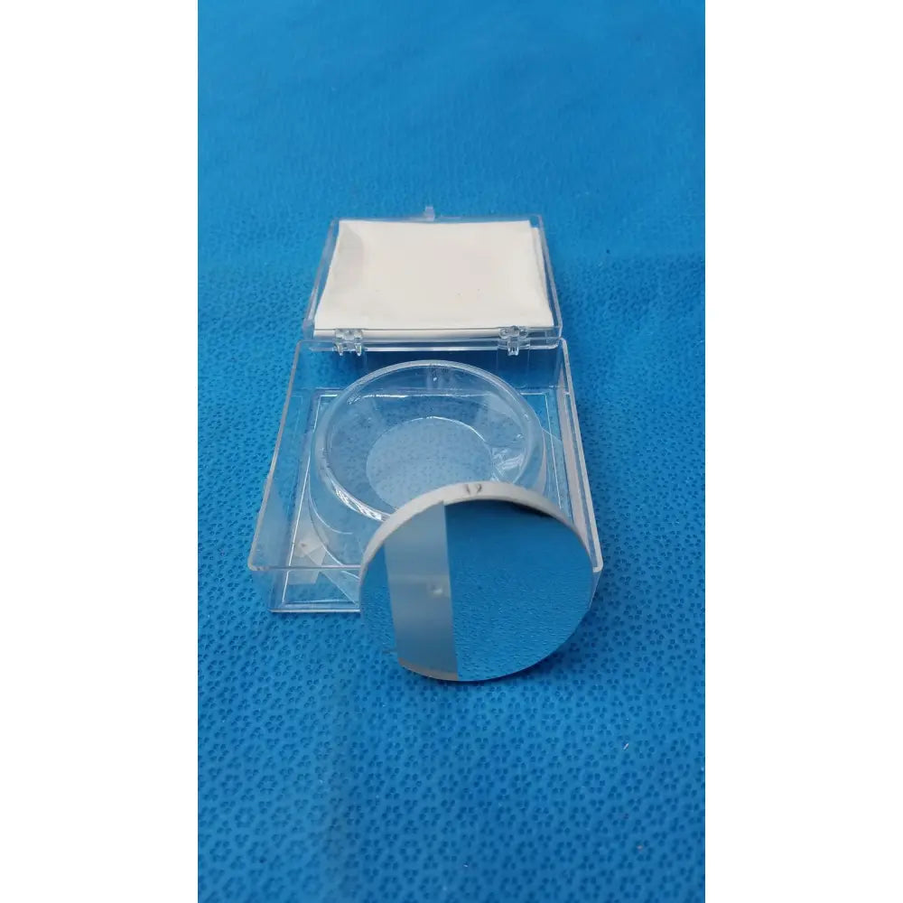 Clear circular optical container with reflective surface in transparent plastic case by Spawr Industries for optical storage