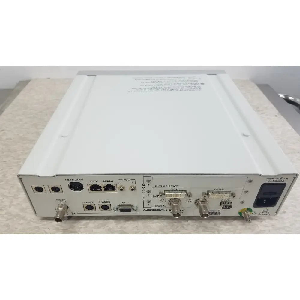 White metal box with multiple labeled ports on the back panel of the optronics microcast 3ccd 1080p hd camera