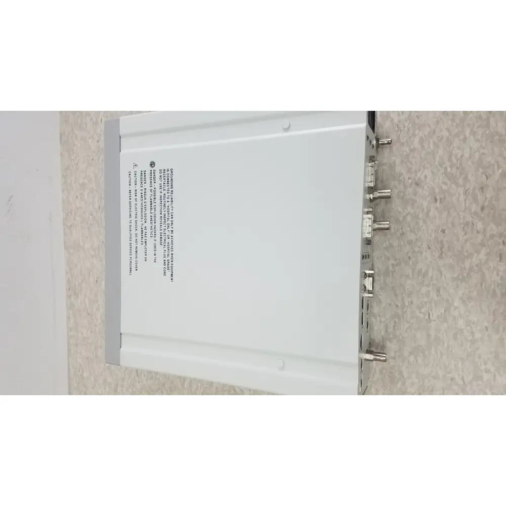 White rectangular optronics microcast 3ccd 1080p hd device with multiple metallic connectors on its back side