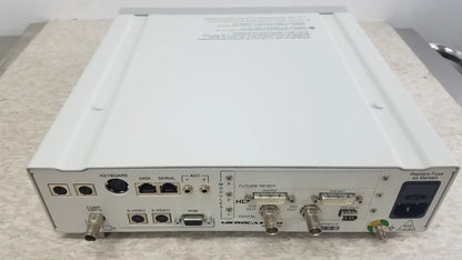 White metal box with multiple labeled ports on the back panel of the optronics microcast 3ccd 1080p hd camera
