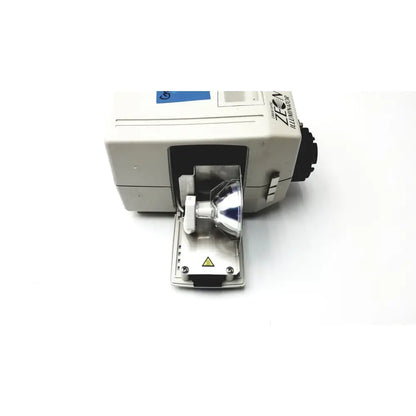 White Orascoptic Zeon illuminator dental fiber-optic light source with silver bulb and black lens housing