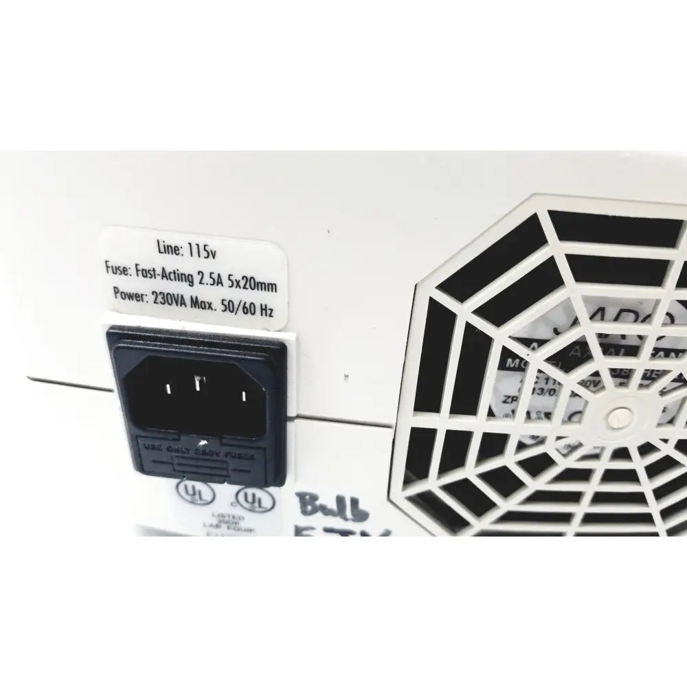 White plastic power input panel with black ac plug and hexagonal vent grille on back side of orascoptic zeon illuminator dental fiber-optic light source