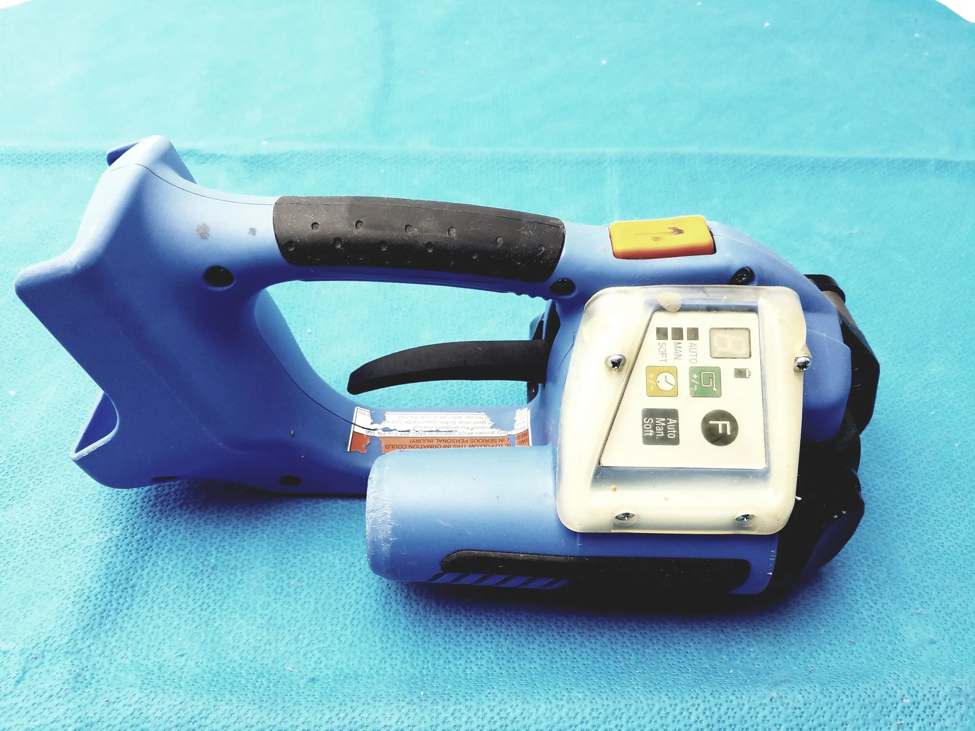 Blue plastic battery operated cordless handheld barcode scanner with black grip and lcd screen for reuse medical equipment