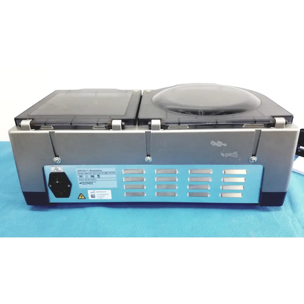 Gray and blue dual-chamber vacuum sealer with transparent lids in sleek design ortho workstation ref ortho clinical diagnostics