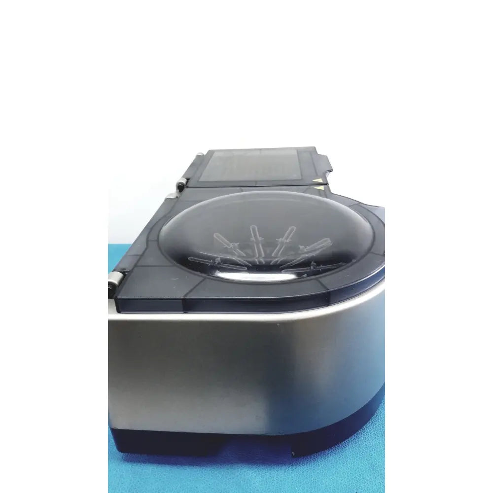 Silver and black laboratory centrifuge with transparent lid and sample tubes in ortho workstation ref 6904630 by ortho clinical diagnostics