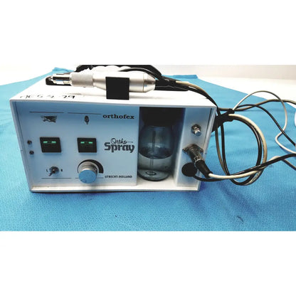 White orthofex ortho spray dental appliance cleaning machine with silver and black handpiece glass reservoir and control knobs professional heavy duty podiatry drill